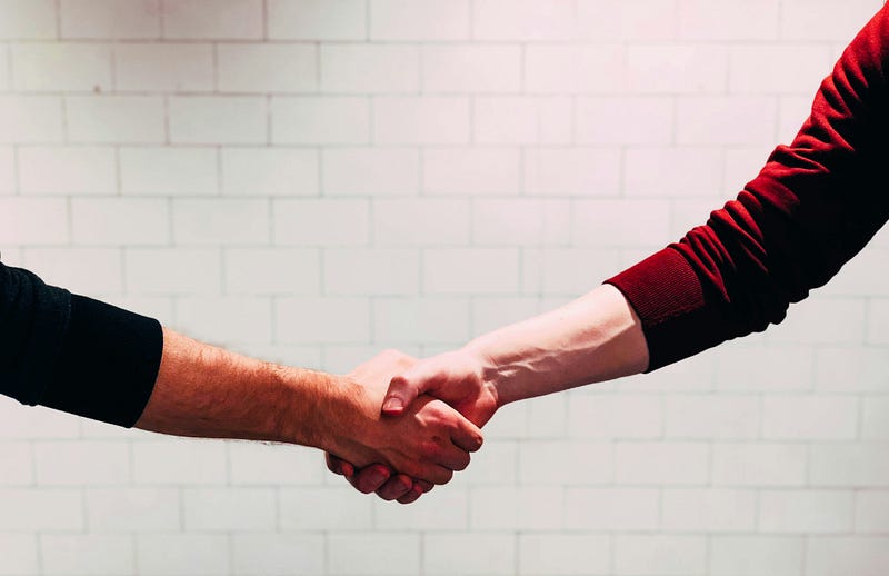 Close-up handshake between two people – business agreement, partnership, and collaboration concept.