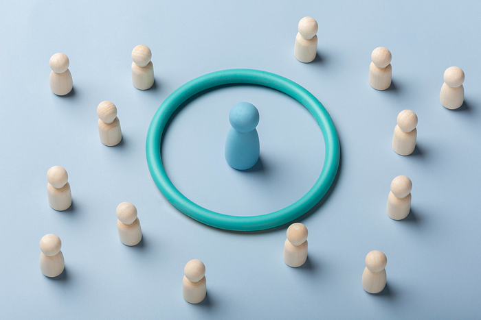 Blue figure surrounded by a ring and smaller white figures – leadership, social distancing, or individuality concept.