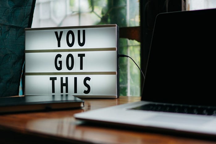 Motivational workspace setup with a ‘You Got This’ lightbox sign – inspiring desk decor with a laptop and natural lighting.