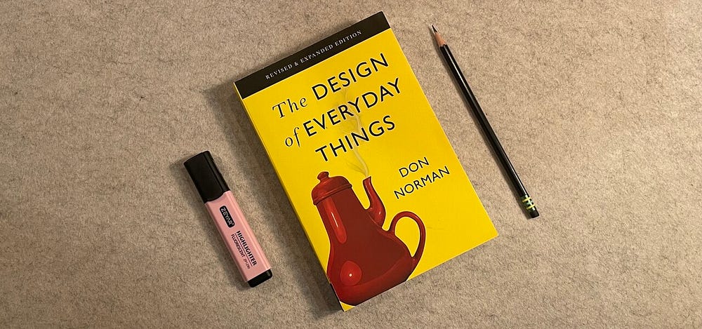 Flat lay of ‘The Design of Everyday Things’ by Don Norman with a highlighter and pencil – essential book on user experience and design principles.